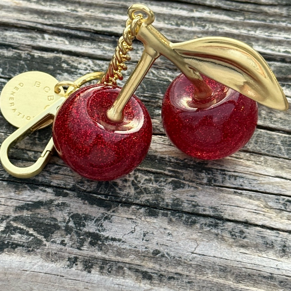 GLITTER CHERRY GOLD ACCENT KEYCHAIN BCBG